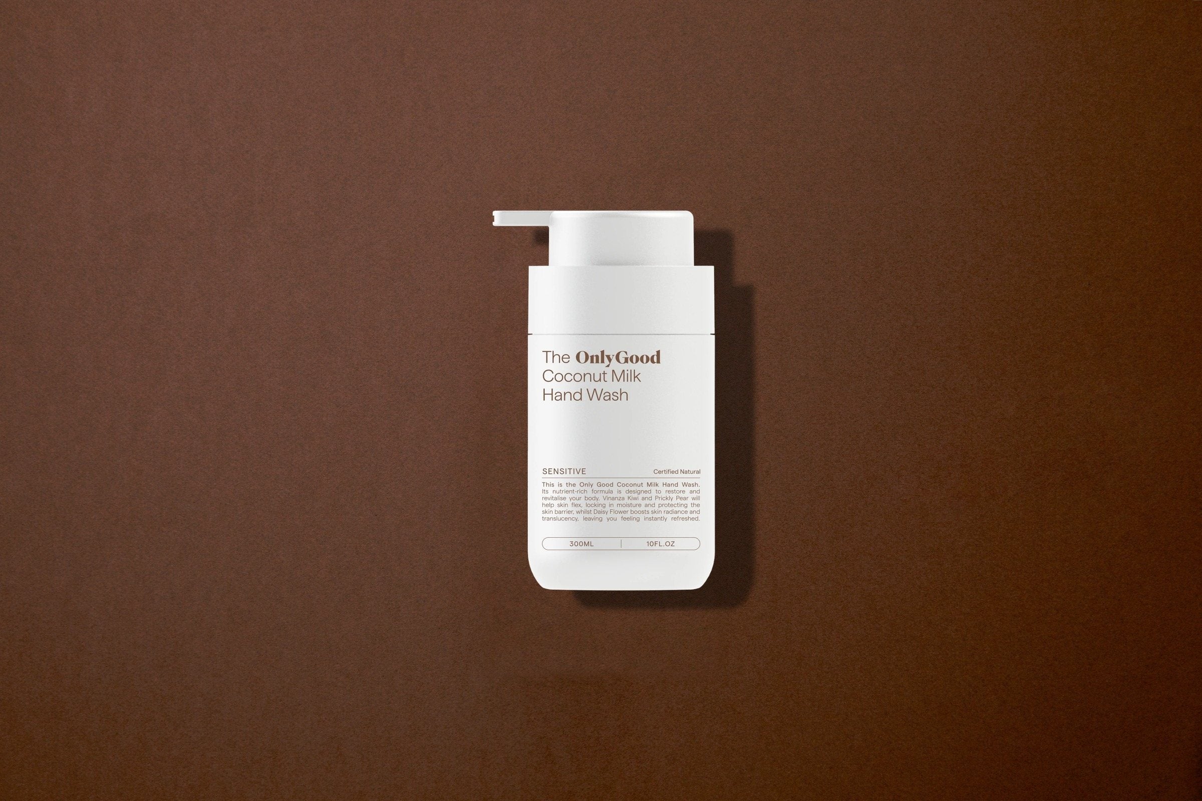 The Coconut Milk Hand Wash lying on brown paper.