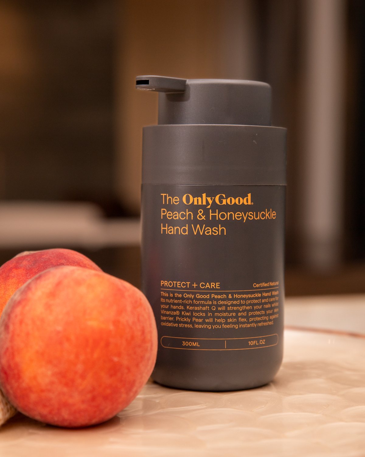 The name screen-printed on the Peach hand wash, beside a peach.