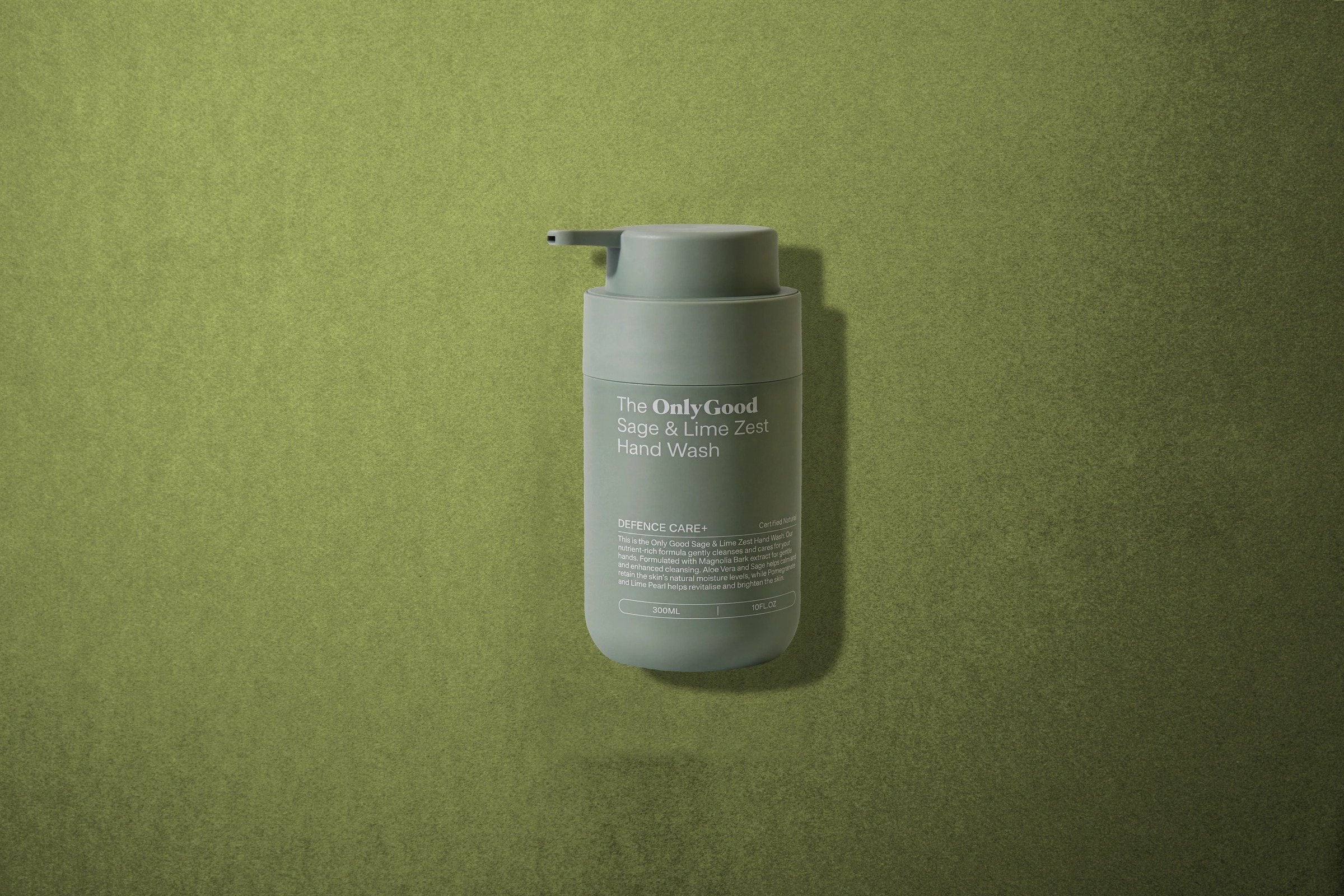 The Sage and Lime Zest Hand Wash lying on sage-green paper.