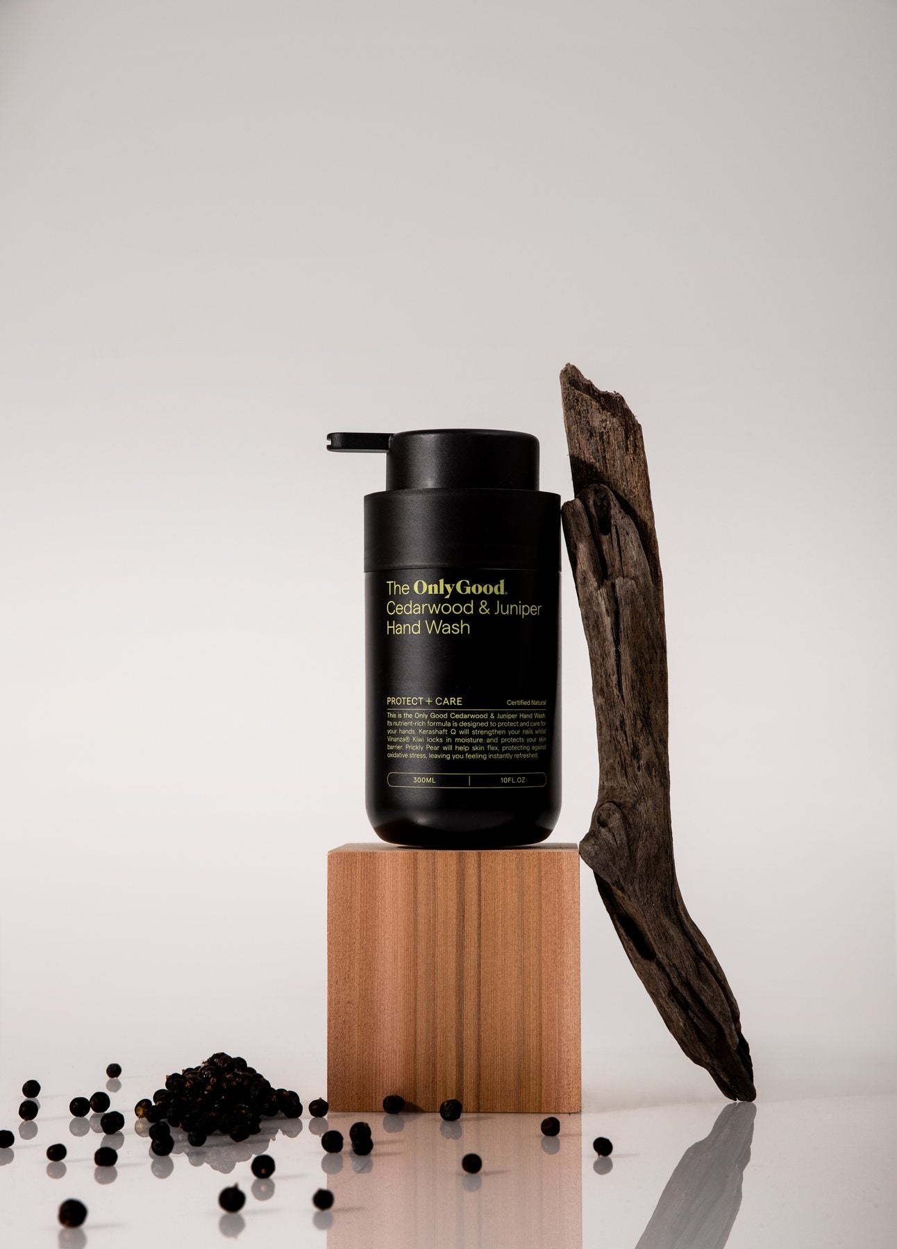 Only Good&reg; Cedarwood & Juniper Hand Wash on a wooden block with driftwood.